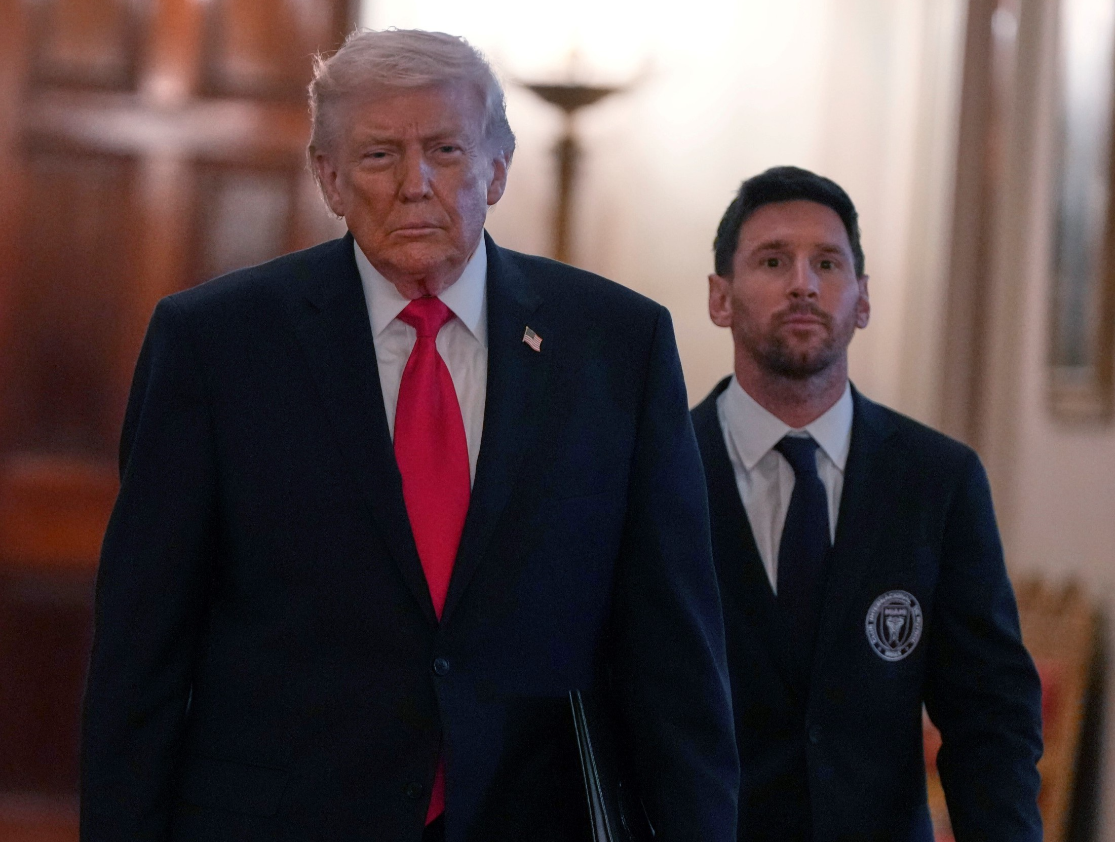 Messi coming to the lectern with Trump