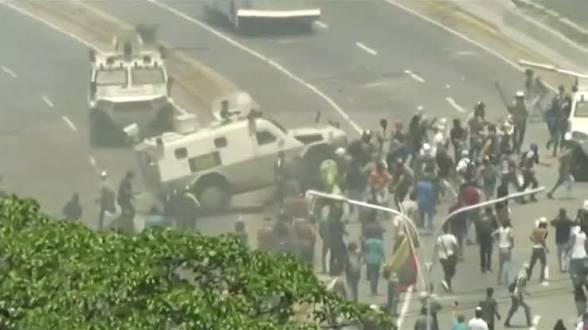 Military tank running over Venezuelan protesters