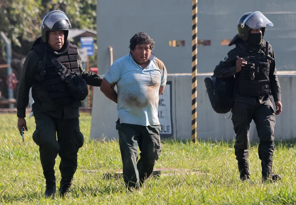 Bolivian police detaining a member of Evo Morales' blockades
