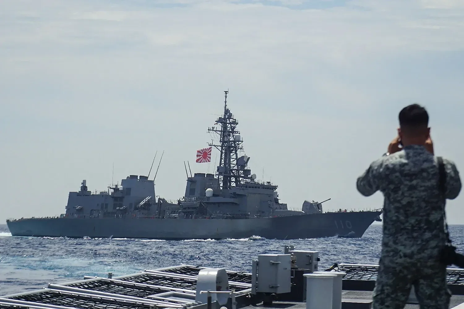 A Filipino sailor observing a Japanese military ship