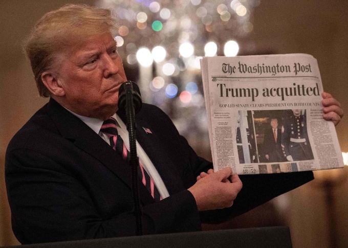2020: Trump celebrates his acquittal in the impeachment trial holding a copy of the Democratic rag The Washington Post.