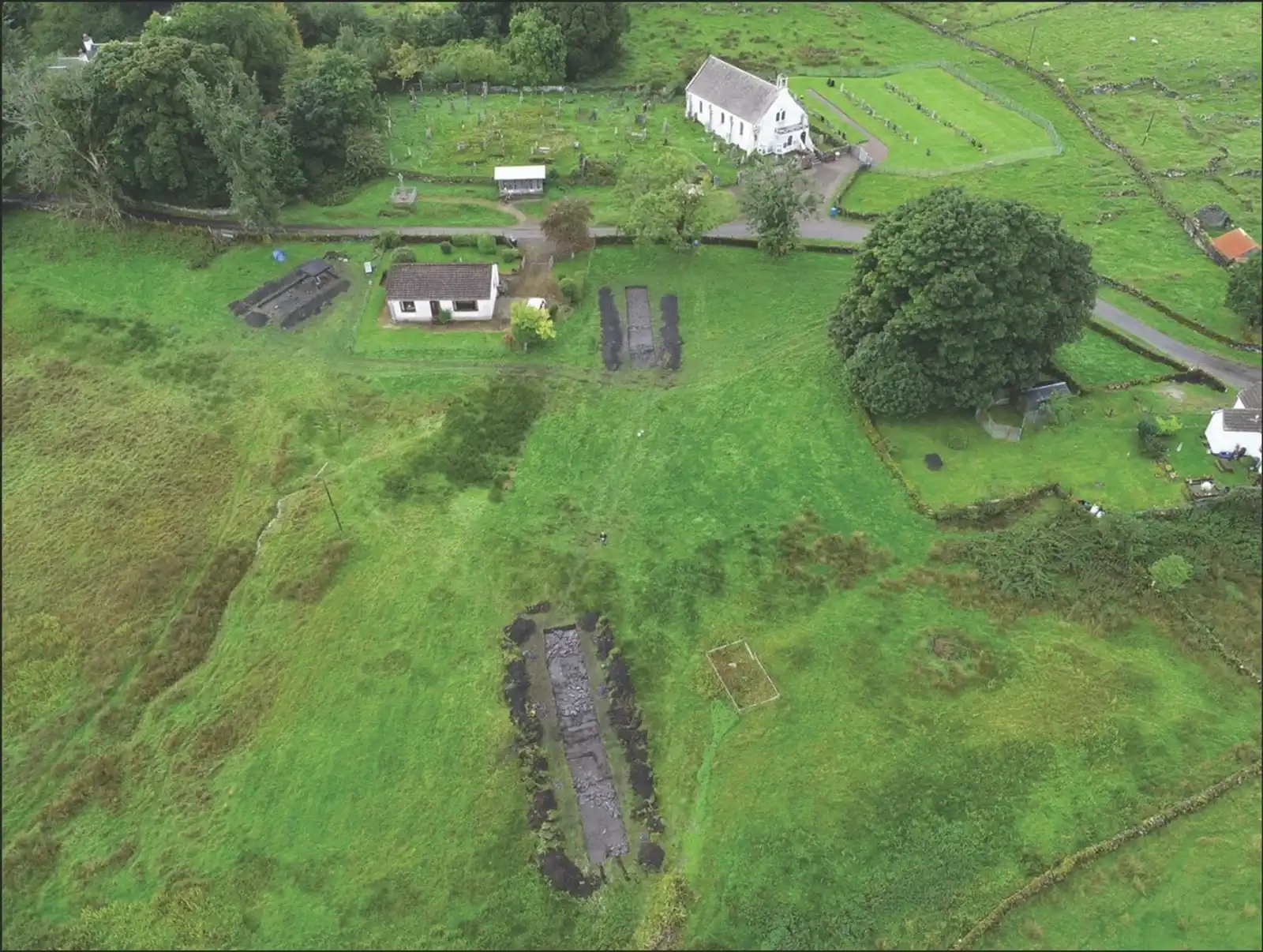 Imagen aérea de las excavaciones en Lios Mòr. En primer plano se observa una zanja que contiene un edificio y una zona de metalurgia